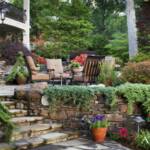 "In Lisa and David Nutt’s backyard oasis, designed by Landscape Associates, creeping juniper and azalea bushes line the Arkansas fieldstone borders of the waterfall and koi pond. A stone walkway leads to a patio with furnishings from Ken Rash’s Arkansas"