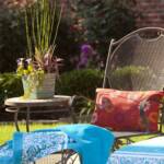 "Woodard iron chaises and mosaic iron side tables are from Ken Rash’s Arkansas; containers are from Botanica Garden."